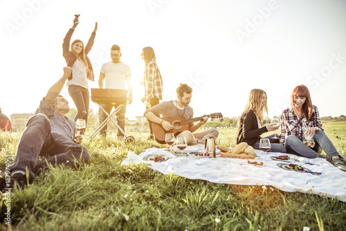 Canvas Print Group of friends having fun while eating and drinking at a pic-nic - Happy peopl