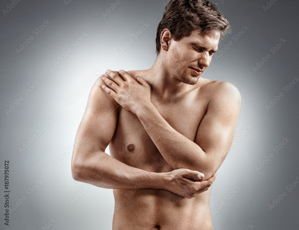 Fototapeta premium Man holding his injured elbow. Medical concept