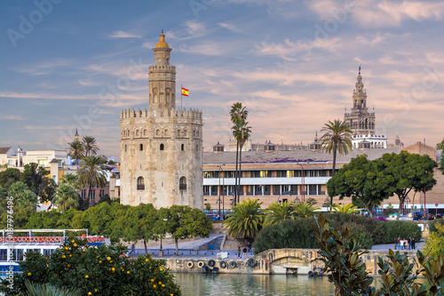 Golden tower (Torre del Oro) at sunset from the other side of the Guadalquivir river, Seville (Andalusia), Spain.