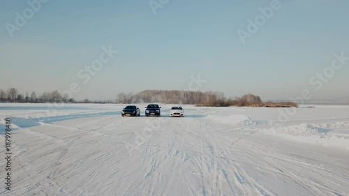 Three Cars stopped in snow road. ars parked on snowy road. Cars ready to race standing on a snowy road photo