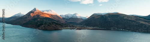 Aerial View of Glencoe and the Mountains Surrounding The Small Town in Scotland photo