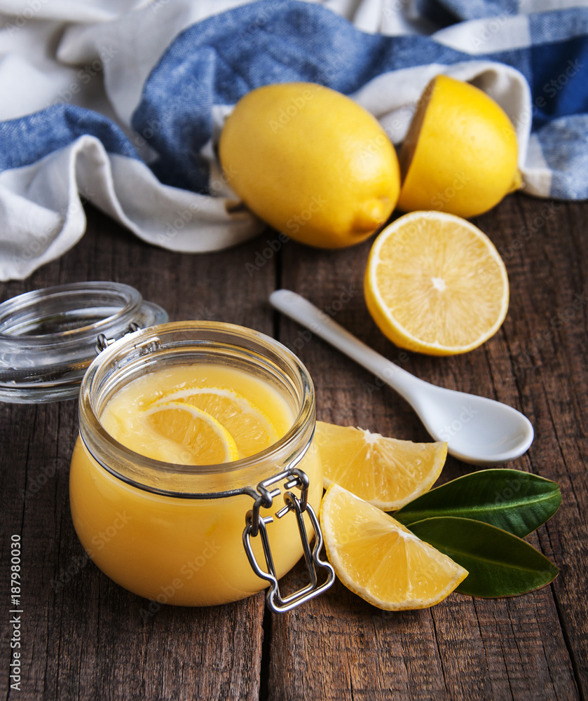 Lemon curd in glass jar with fresh lemons Lemon curd in glass jar with fresh lemons