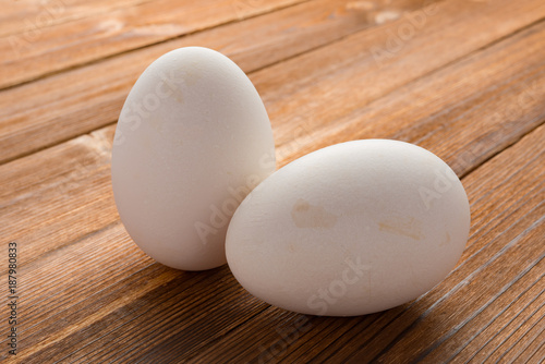 clean goose eggs on wood background