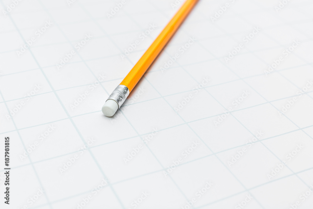 Yellow pencil on white paper Yellow pencil on white paper