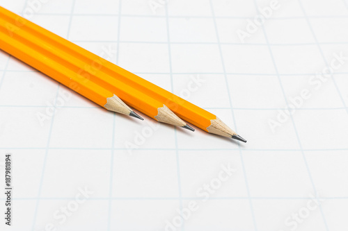 Three yellow pencil on white paper