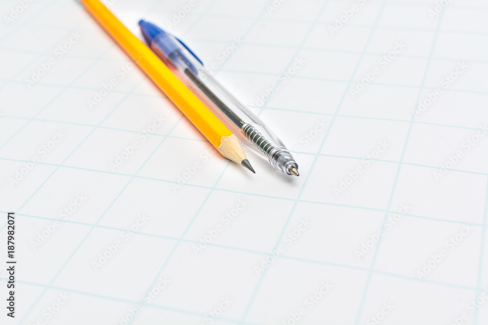 Yellow pencil and blue pen on white paper Yellow pencil and blue pen on white paper