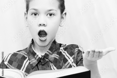 Beautiful child retells the plot of the book with hand