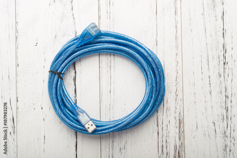 top view blue usb cable on a white wood background top view blue usb cable on a white wood background