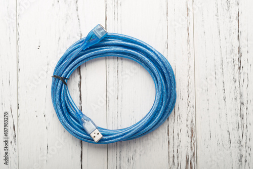 top view blue usb cable on a white wood background