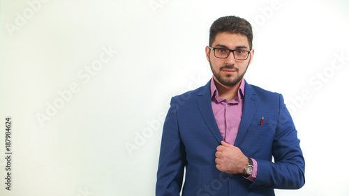 Portrait of young businessman with beard in business suit on white background photo