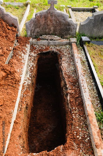 Canvas Print Open grave, freshly dug and awaiting burial.