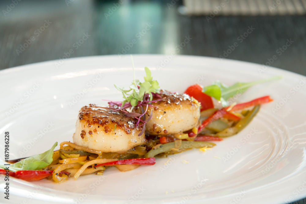  Grilled scallops on a white plate