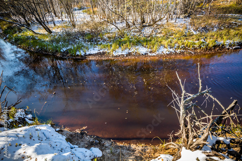 Fototapeta Naklejka Na Ścianę i Meble -  Forest winter flow river lies and strikes the shores of the Siberian taiga