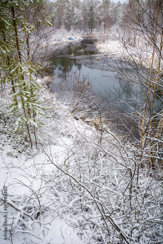 Forest winter flow river lies and strikes the shores of the Siberian taiga Forest winter flow river lies and strikes the shores of the Siberian taiga