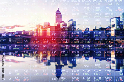 Double exposure of stocks market chart in blue on LED display concept with city scape hong kong background photo