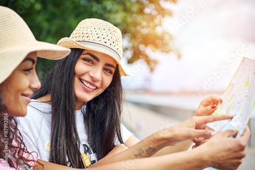 Smiling young woman enjoying the day sightseeing with a friend