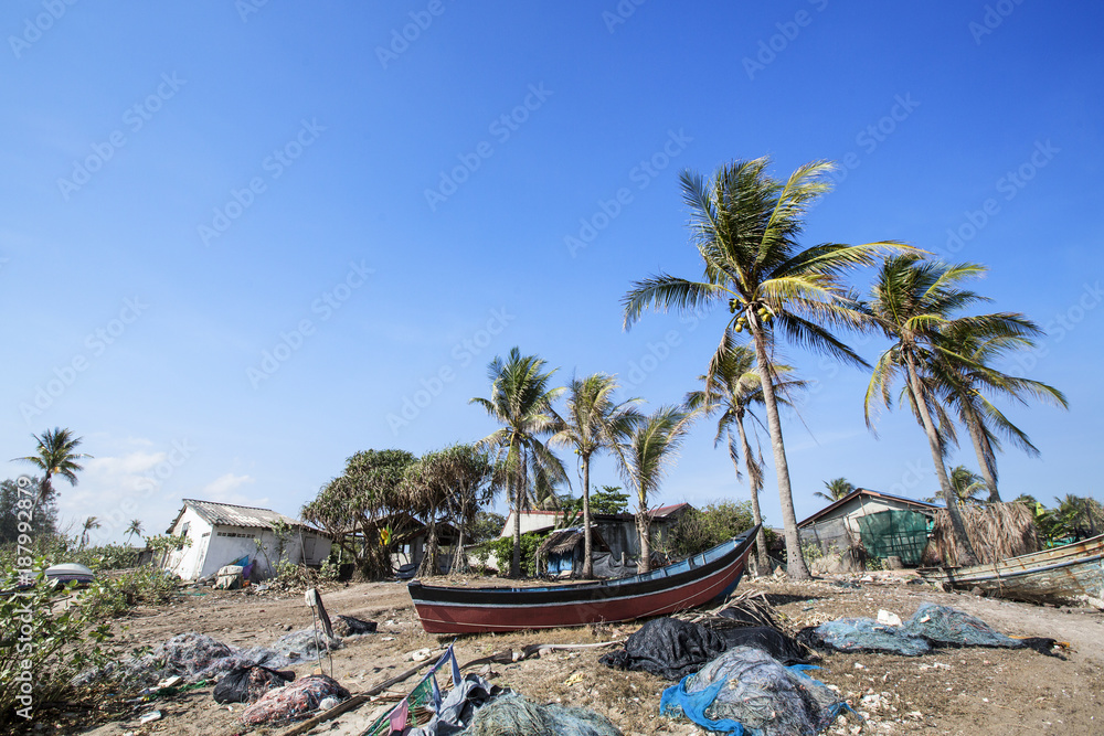 Fishing village with beach pollution after storm