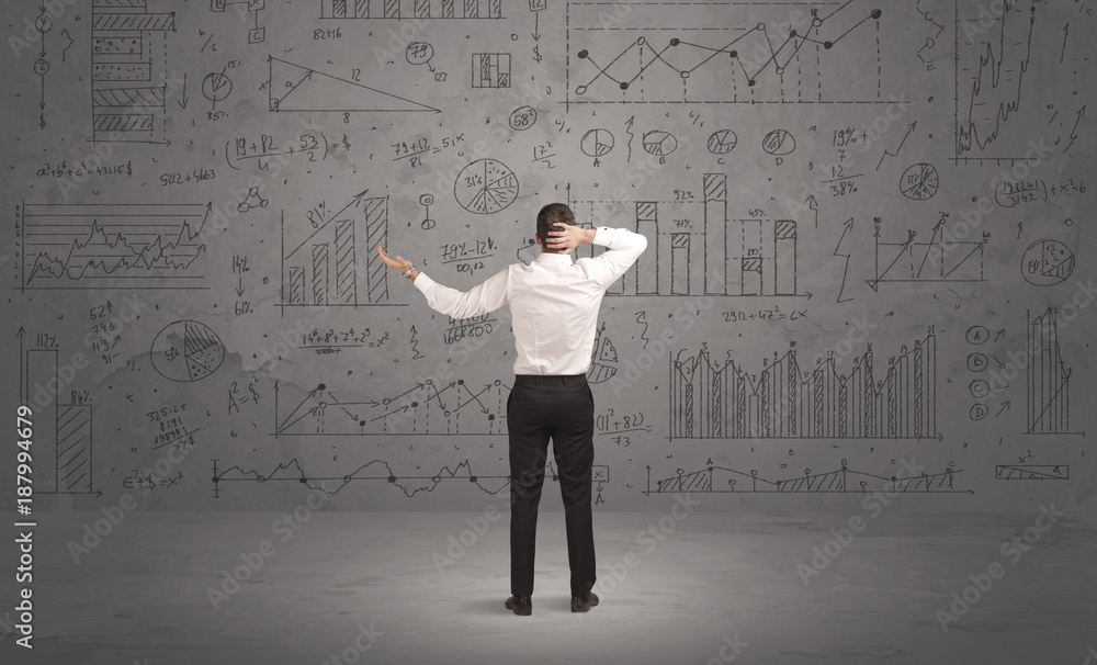 Salesman with business charts on wall Salesman with business charts on wall