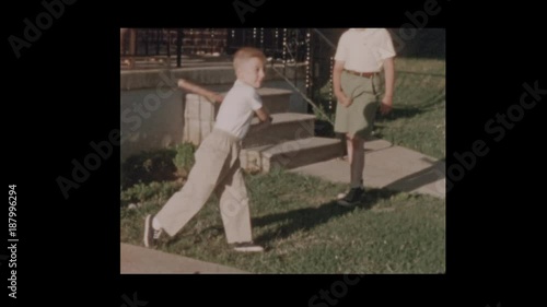 50's father and son play baseball