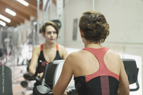 The girl in the gym is engaged in fitness. Healthy lifestyle.