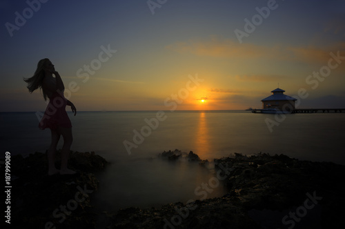 Woman up at sunrise on beach