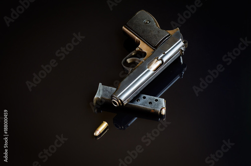 Handgun, charger and bullet. © adonsky