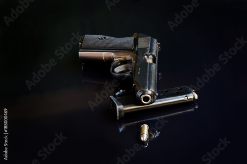 Handgun on black reflective background
