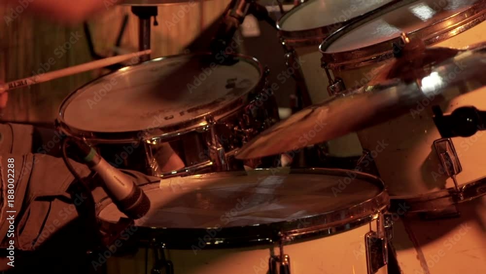 Close-up of drums, drum sticks and drummer's hands, in sequential order. Close-up of drums, drum sticks and drummer's hands, in sequential order.