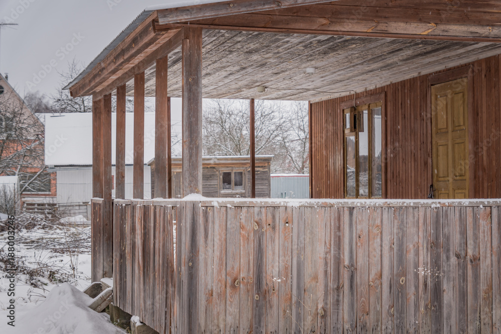 unfinished country house in winter. Closeup of wooden terrace