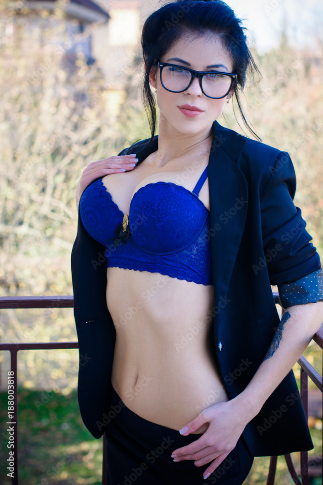 Sexy attractive woman in glasses with big breast wear in black jacket and  bra on a balcony Stock Photo | Adobe Stock