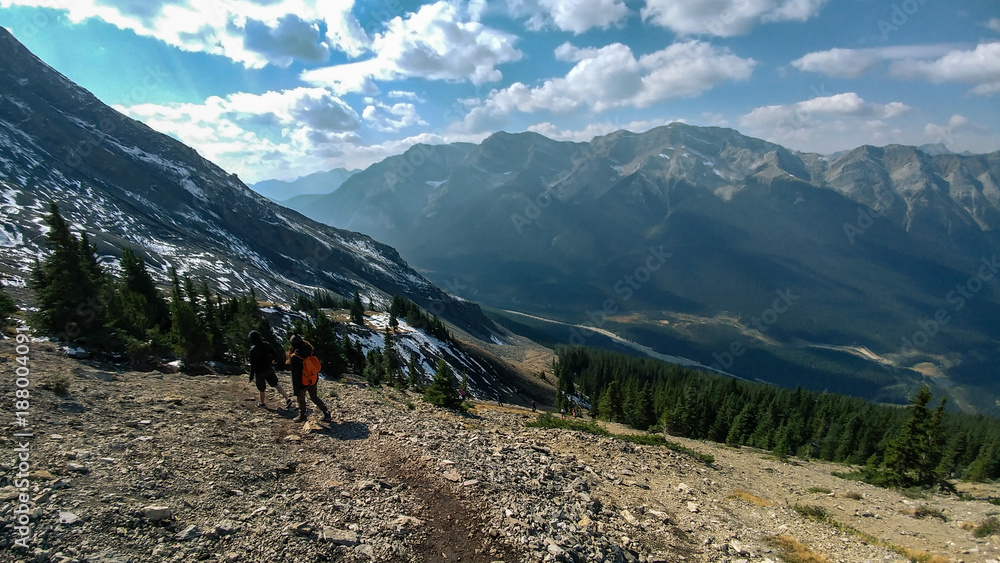 Hikers on Ha Link Peak's way down, with Canadian Rocky Mountains on background