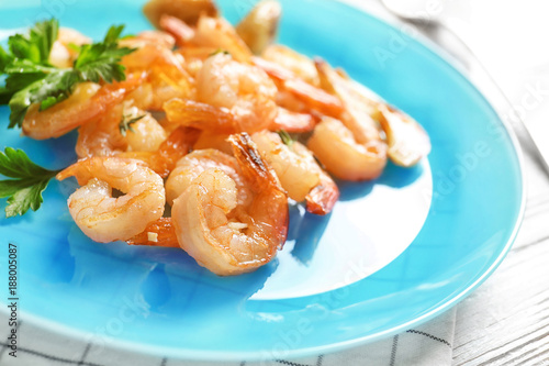 Plate with delicious fried shrimps and chopped garlic, closeup