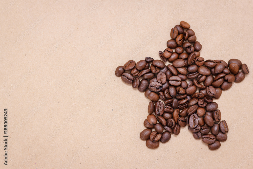 Star from coffee beans on craft paper background Star from coffee beans on craft paper background