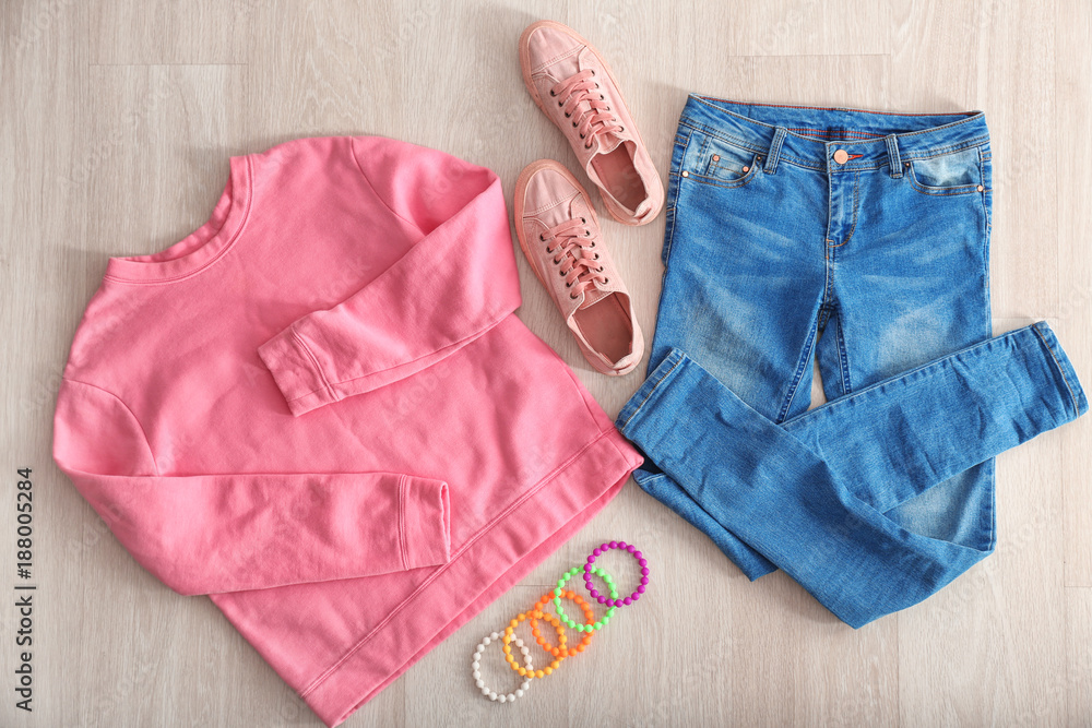 Set of stylish female clothes on light background, top view Set of stylish female clothes on light background, top view