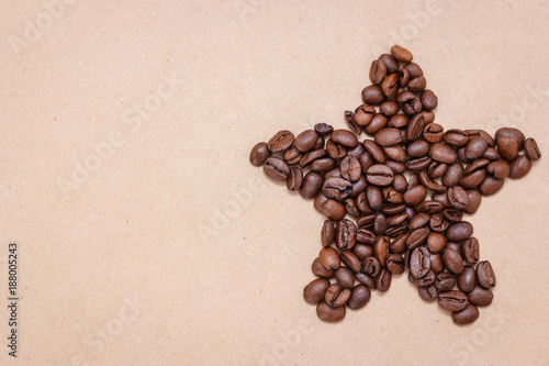 Star from coffee beans on craft paper  background
