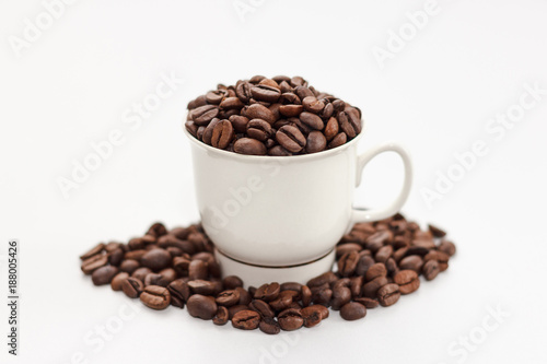 Coffee beans in coffee cup on white background