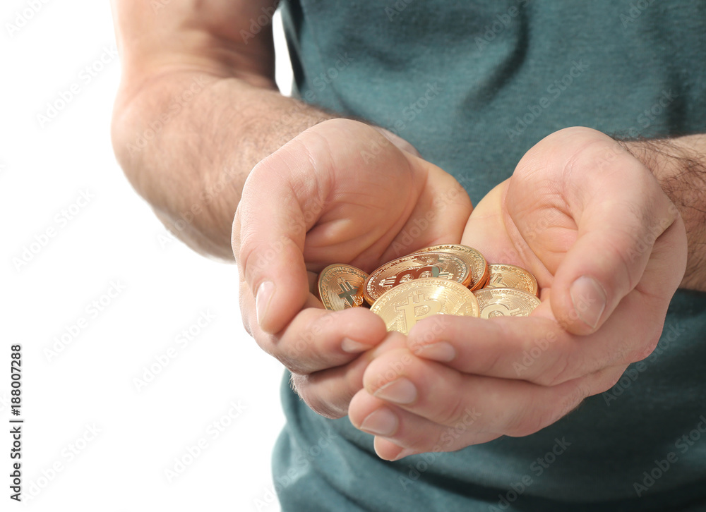Man with golden bitcoins on white background, closeup Man with golden bitcoins on white background, closeup
