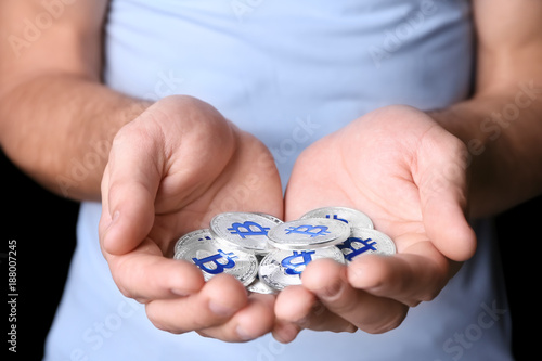 Man holding silver bitcoins, closeup