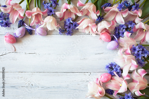 Easter wooden background with tulips, hyacinths and decorative eggs