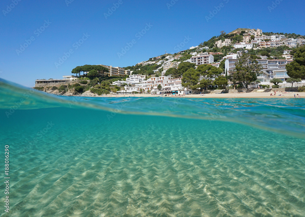 Over and under water, a sandy seabed and coastline with buildings, Spain, Costa Brava, Mediterranean, playa Almadrava, Canyelles Grosses, Roses, Girona, Catalonia