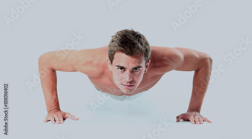 Young man doing push up exercise.