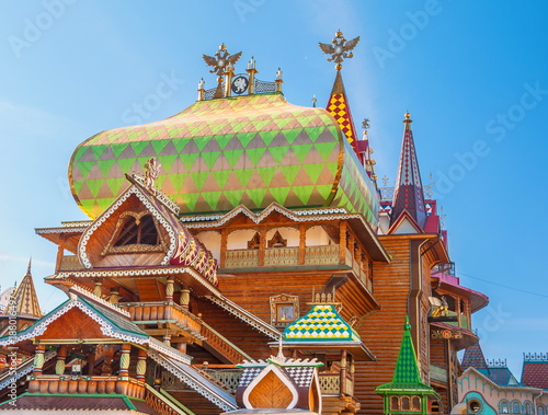 Terem with porches, towers, wind vanes is decorated with wood carvings - sample of wooden Old Russian architecture photo