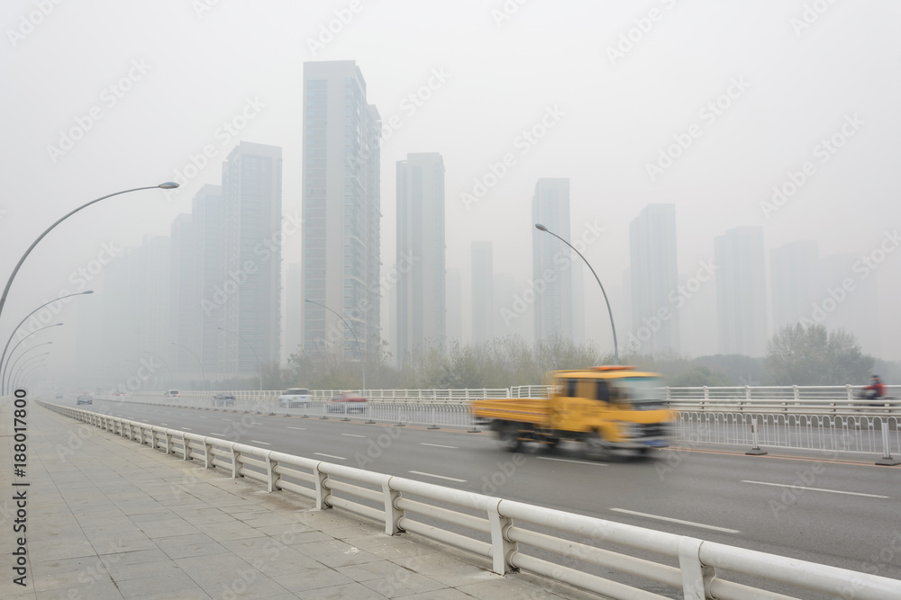 Fototapeta premium City in a heavy hazy weather. The deterioration of air quality resulted in low horizontal visibility. Located in Sanhao Bridge, Shenyang, Liaoning, China.