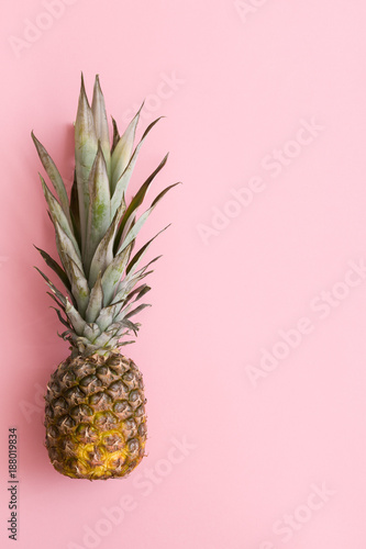 Top view on fresh organic pineapple on light oink background. Fruit.