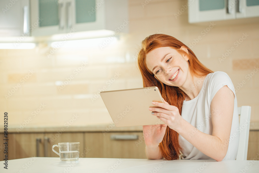 Happy woman working using digital tablet on desk at home Happy woman working using digital tablet on desk at home