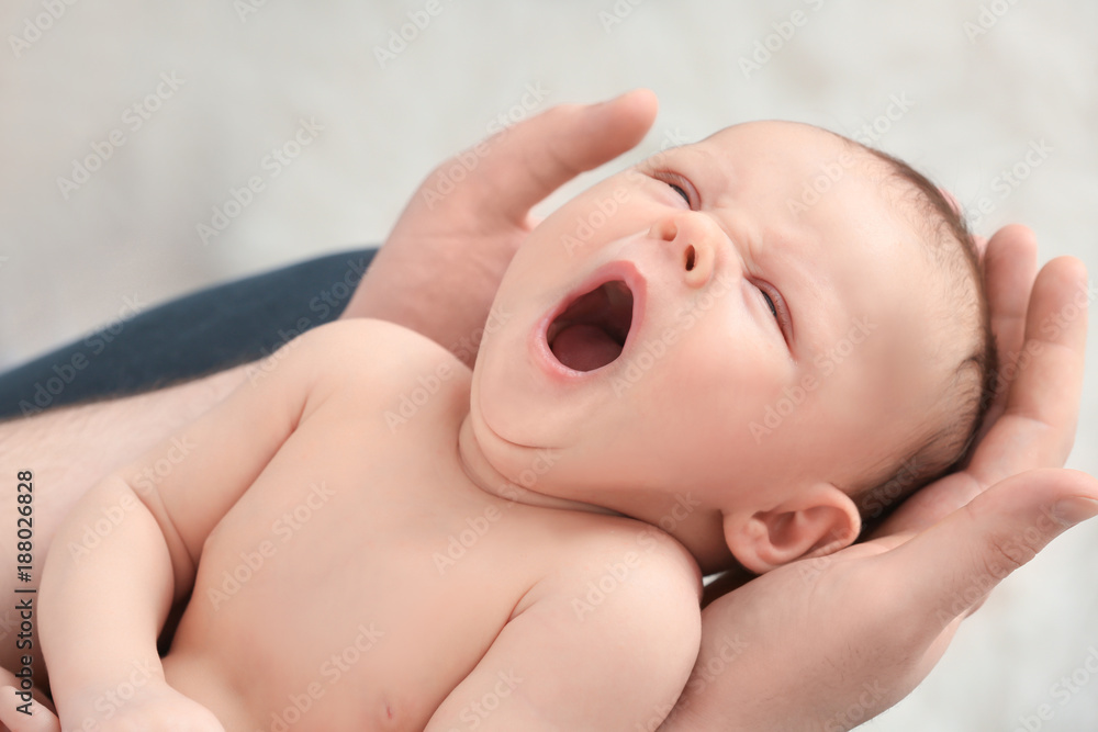 Father holding cute yawning newborn baby, closeup Father holding cute yawning newborn baby, closeup