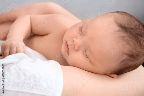 Parent holding sleeping newborn, closeup