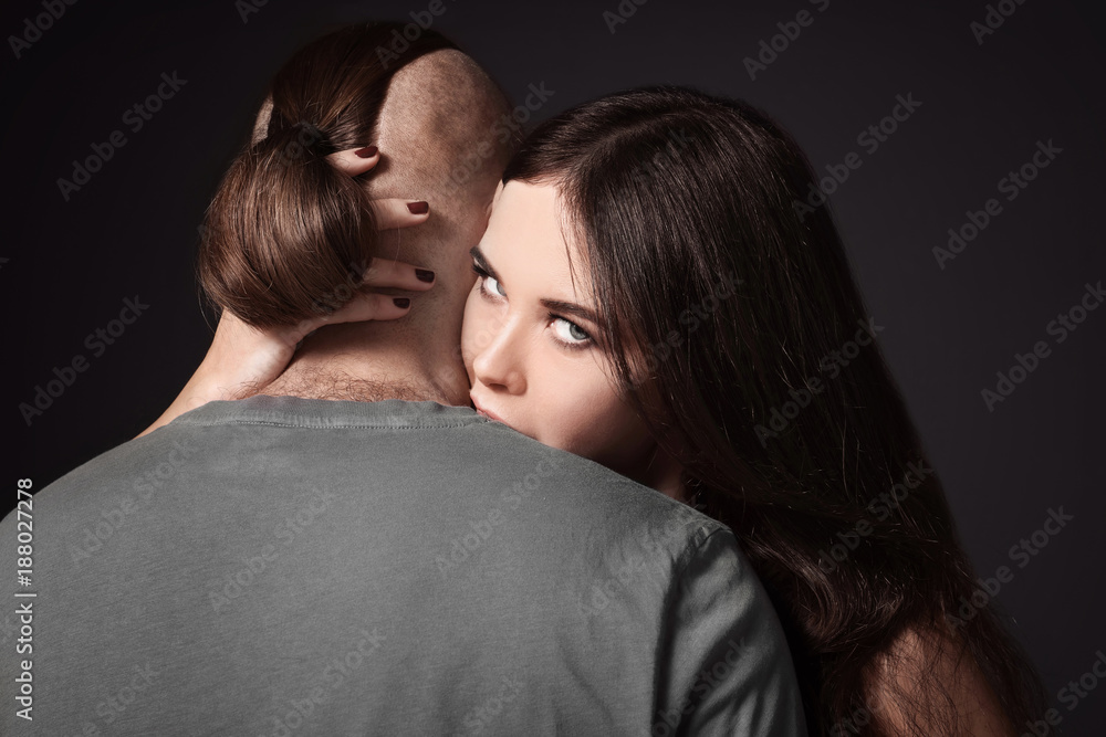 Attractive young couple on dark background Attractive young couple on dark background