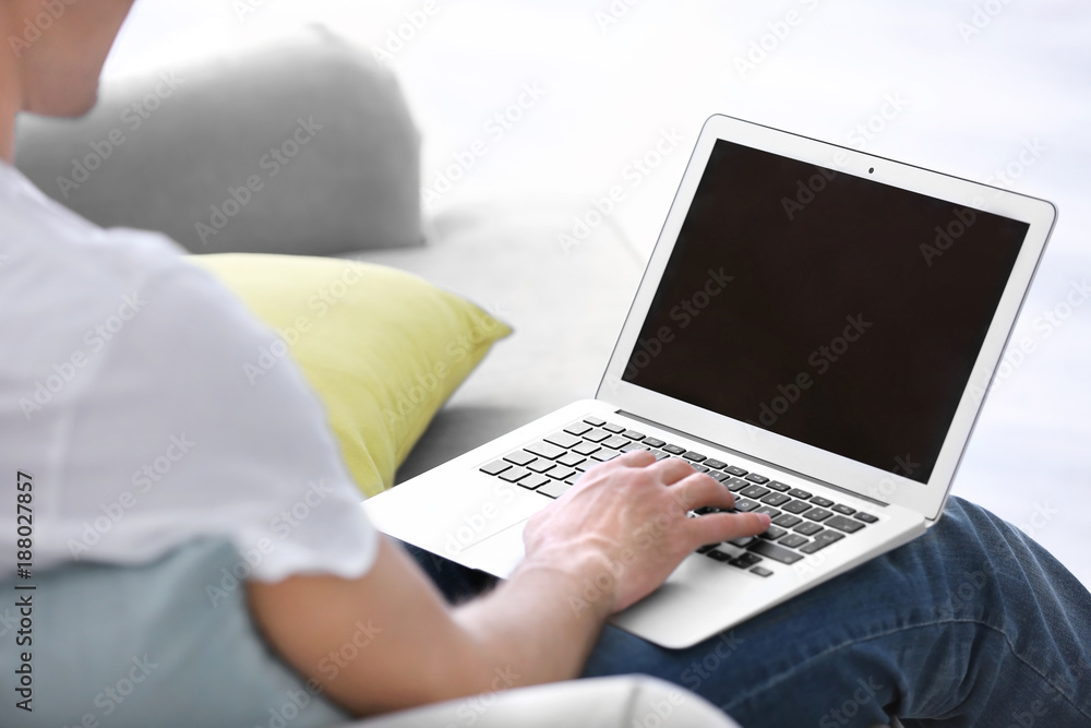 Man using laptop indoors, closeup Man using laptop indoors, closeup