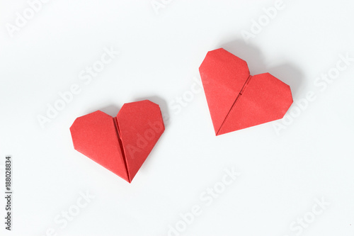 Two red origami hearts on white background. Valentin's Day gift cards. Top view. photo
